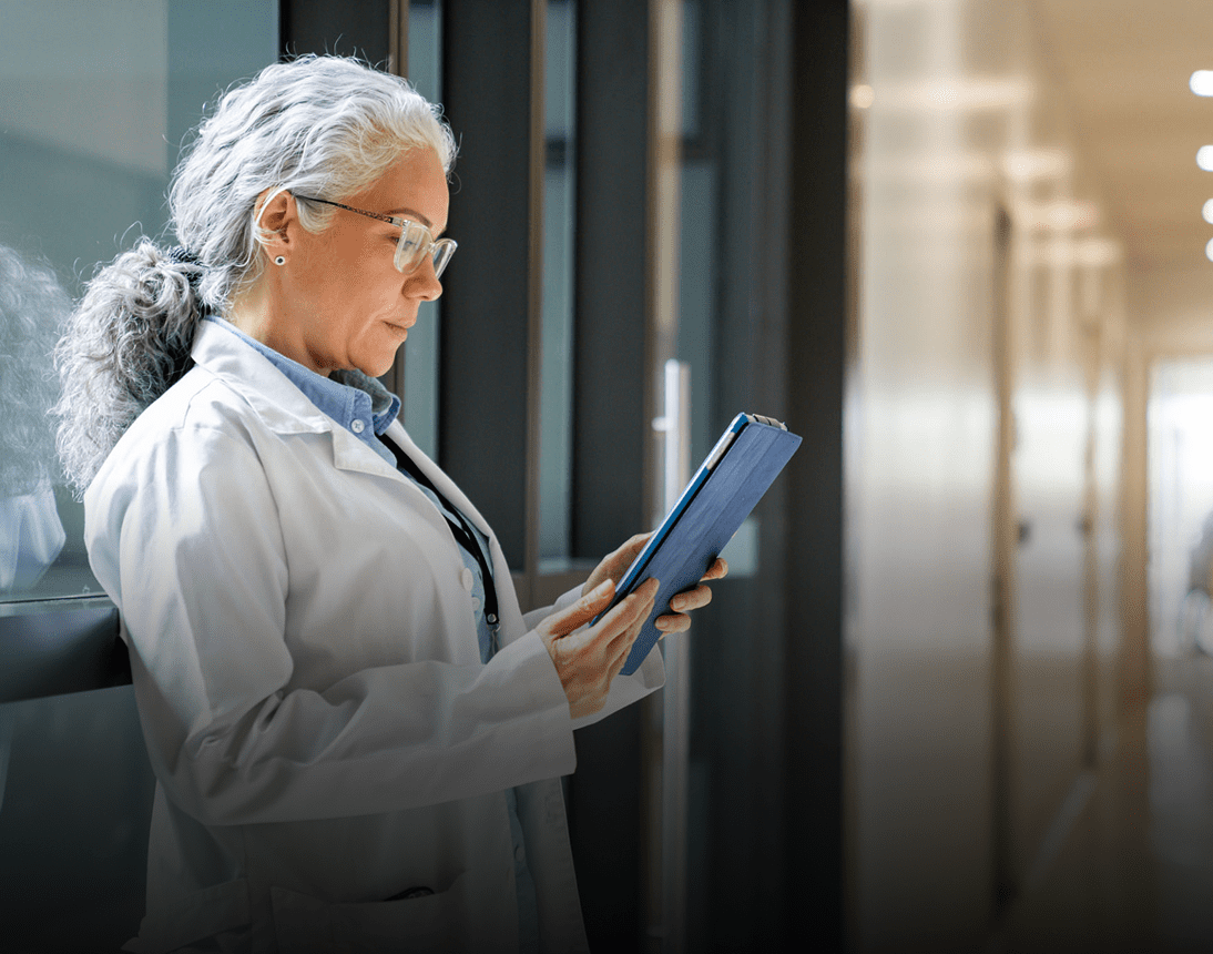 Doctor with tablet in corridor
