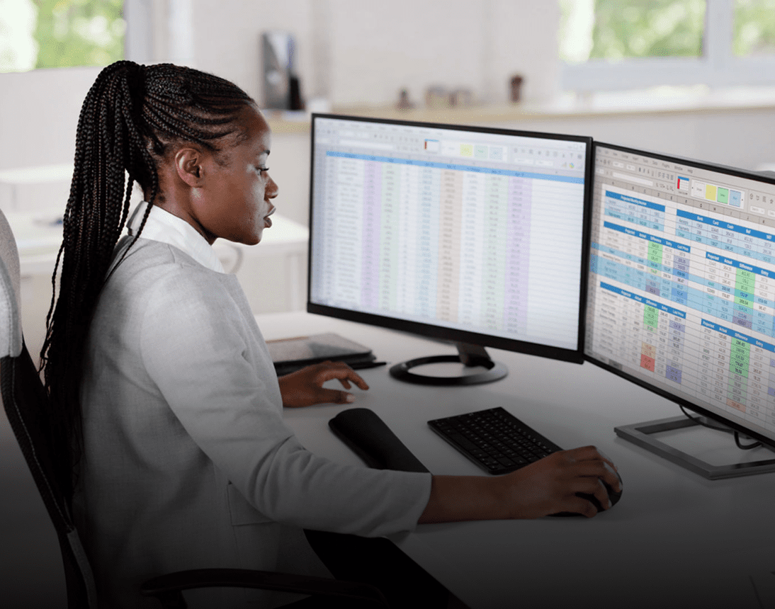 Office professional analyzing data on screens
