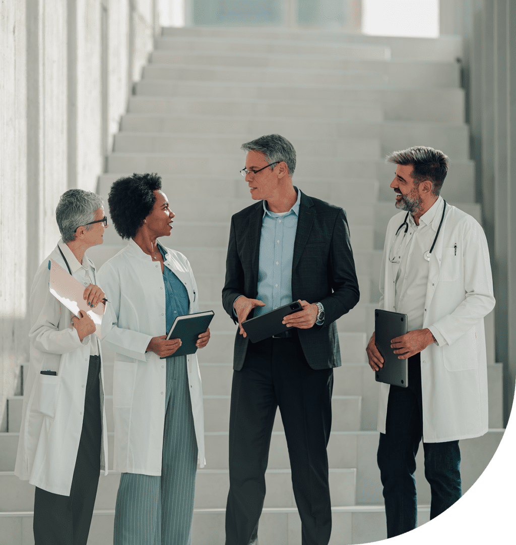Medical professionals conversing with businessperson